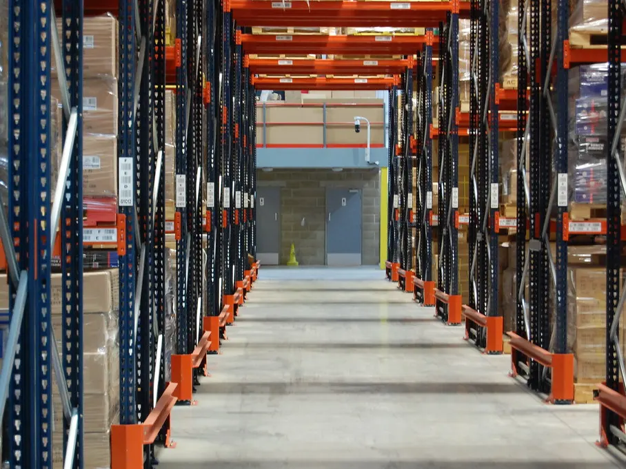 Long warehouse aisle lined with pallet racking